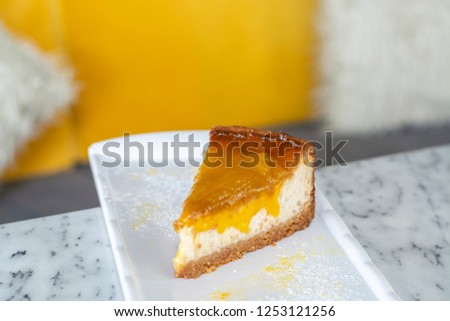 Delicious mango lime cheesecake on white plate