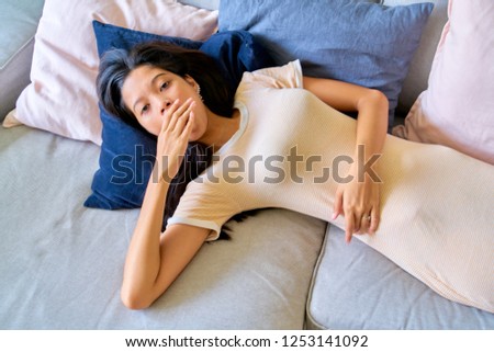 Beautiful woman posing - lying down, sleepy, yawning and resting