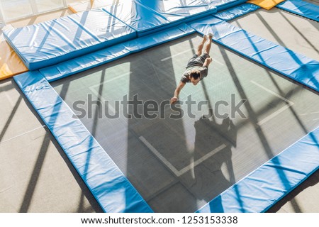 jumping area. jumping surface. super fun trampolines. full length photo. copy space. tips fot jumpers. spiderman over the trampoline