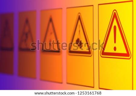 Warning signs in the form of a triangle of different symbols on the information Board near the construction site.