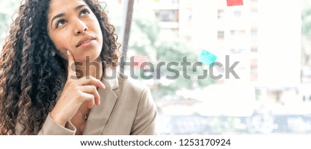Business woman at the office thinking about an important decision to make.