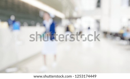 Blur abstract background perspective view of aisle in hospital building. Defocused blurry nurse working at light hallway interior corridor in clean clinic. 