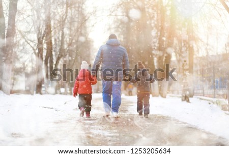 Children play outside in the winter. Snow games in the street.