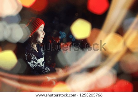 Little girl in red hat waiting for santa claus
