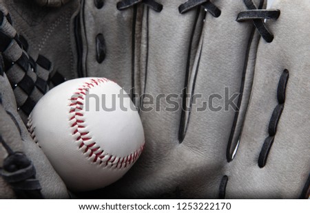 old used baseball glove and ball isolated on white closeup