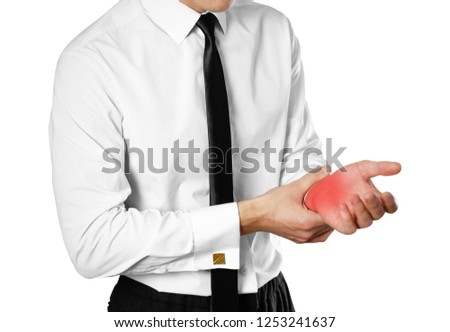 Businessman in a white shirt and tie holding hand. Pain in the wrist. Isolated on white background.