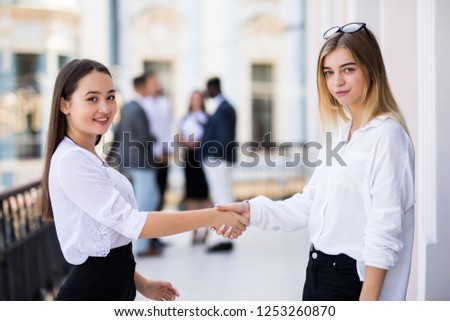 Image of two confident businesswomen handshaking