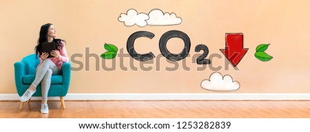 Reduce CO2 with young woman holding a tablet computer in a chair