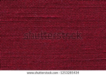 Red fabric of cloth texture background. Detail of textile material close up.