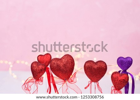 St. Valentine Day background. Border from colorful  hearts  and  fairy lights  against pink  background. Selective focus. Place for text. 