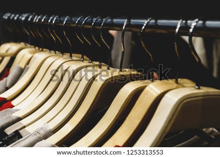 Hangers with clothes in a row in the store. Illustration.