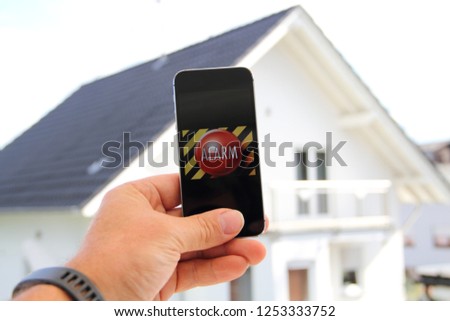 Mobile phone with a picture alarm system and the text "Alarm"
