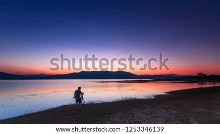 Landscape of sunset and photographer