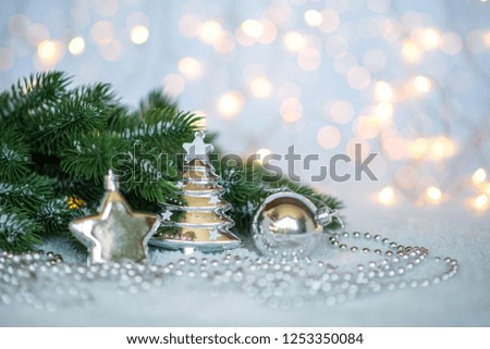 Christmas background and Christmas decorations with snow, blurred, sparking, glowing. Happy New Year and Xmas theme. Toned image with copy space. Selective focus.