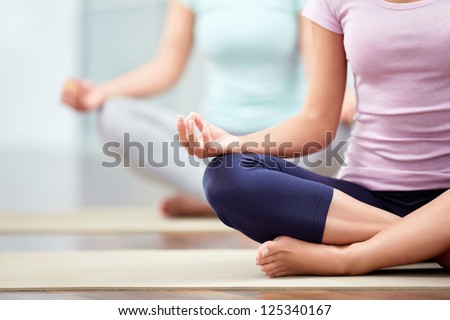Young people do yoga indoors Royalty-Free Stock Photo #125340167
