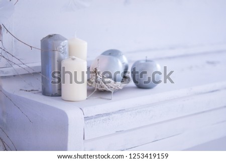 White room christmas interior decor with hand-made candle and bouq on a white piano