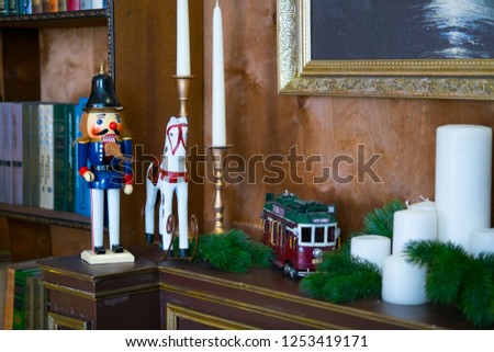 Nutcracker doll on the mantelpiece in the library. Book is the background