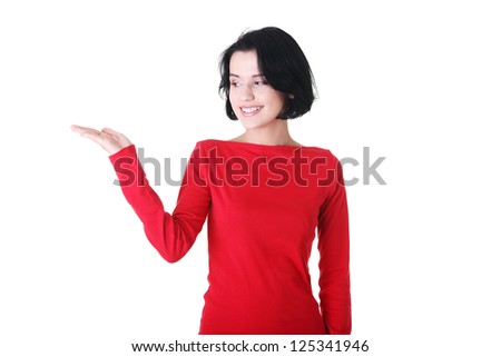 Happy , excited young woman presenting copy space on her palm, isolated on white