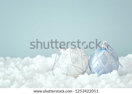 Image of christmas festive tree white ball decoration in front of pastel blue background