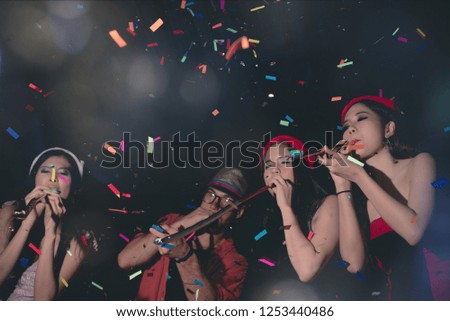 Group of Fun Party People Enjoy with Colorful Confetti in Nightclub while Dancing in Happy Emotion with Friends - Lifestyle on Holiday
