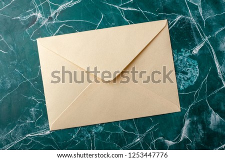 light brown envelope on turquoise background. top view. Mock-up