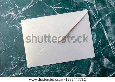 White envelope on blue background. top view. Mock-up