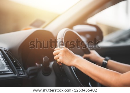 Close Up of Woman Driving a Car on Road - Transportation Concept Royalty-Free Stock Photo #1253455402