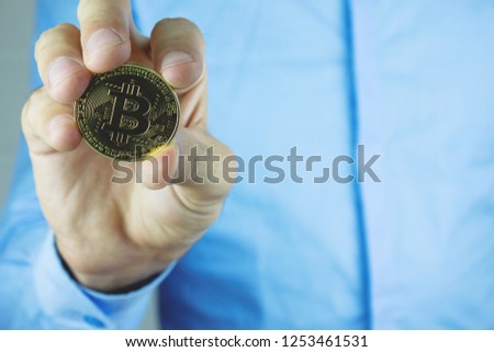 

Businessman holding golden bitcoin. 