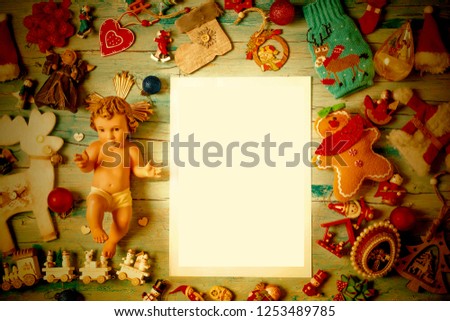 Christmas  blank frame background cards. Child Jesus figurine and very much Christmas ornaments with empty frame to write greeting message or put photos.