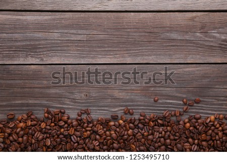 Coffee beans on grey wooden background
