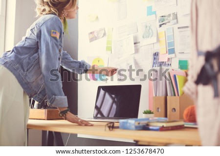 Fashion designer woman working on her designs in the studio