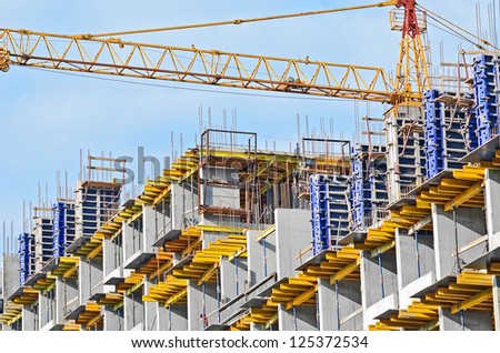 Concrete formwork and crane on construction site Royalty-Free Stock Photo #125372534