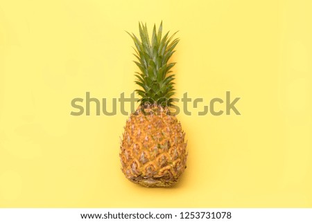Fresh pineapples on a yellow background