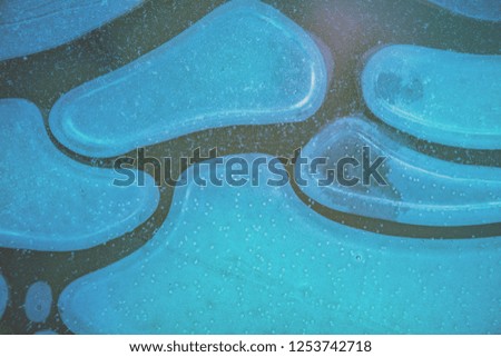 Natural abstract pattern on frozen puddle. Nature background