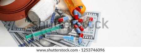 Money dollars used syringe pills and unknown powder drug trafficking making background. Law for the legalization of light use drugs adoption concept