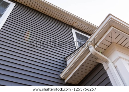 vinyl siding up the side of a new house Royalty-Free Stock Photo #1253756257