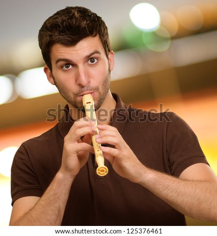 Portrait Of A Young Man Playing Flute, Outdoors
