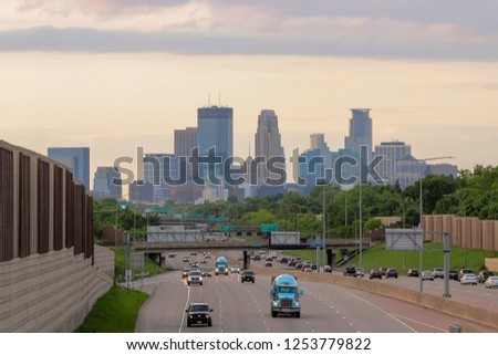 A Telephoto Close Up of Downtown Minneapolis Compressed against Highway Traffic during a Beautiful Summer Golden Hour