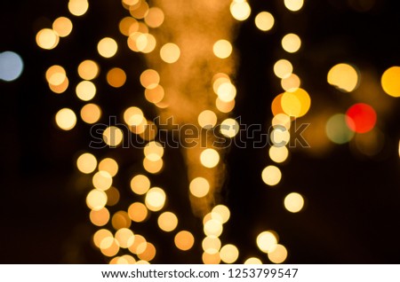 Abstract gold soft blurred bokeh on black background. Shining and blurred circles background. For used wallpaper texture and background with copy space area for a text. 