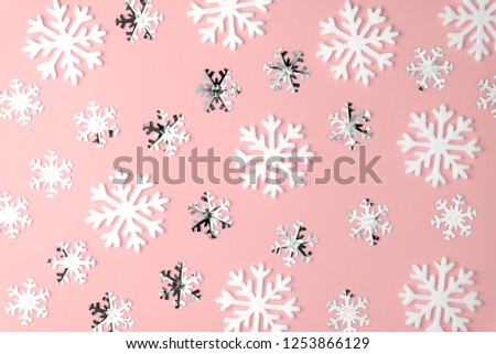 Christmas snowflake pattern flat lay on pink pastel  background. Top view. Minimal concept.