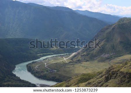 Superb mountain landscape with the turquoise river "Katun". Wonderful view from the top of the mountain. Russia, mountain Altai. Atmospheric juicy summer and Russian nature