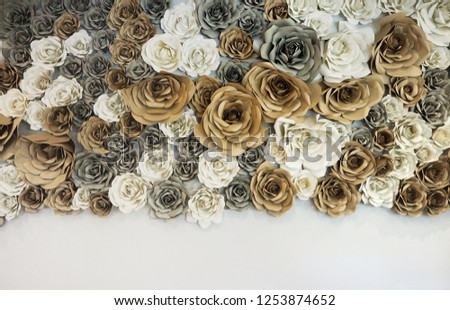 The flowers made from paper decorating white wall