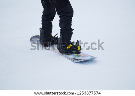 a snowboarder rides a snowboard