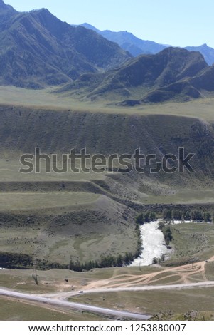 Excellent mountain landscape with a turbulent mountain river "Chuya". Wonderful view from the mountain. Russia, mountain Altai. Atmospheric juicy summer and Russian nature
