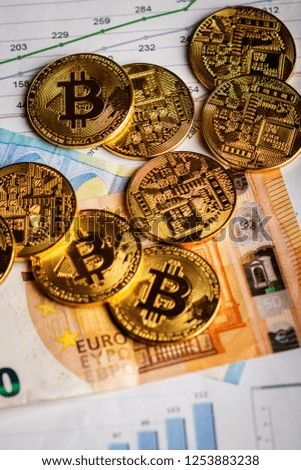Golden  coins of crypto currency Bitcoin and Euro paper money