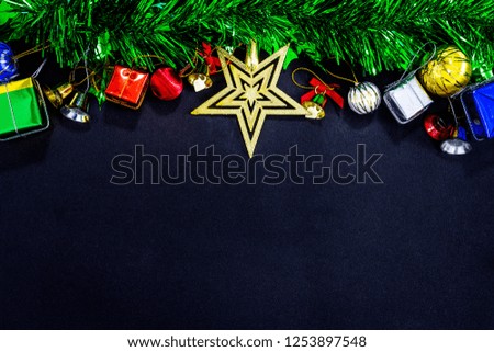 Top view image of Christmas festive decorations with empty on black paper background, New Year concept.