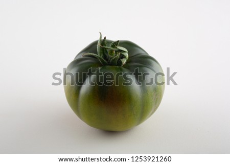 green Raf Tomato isolated on white background. With clipping path. Full depth of field.