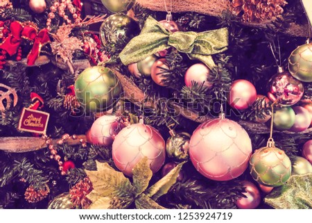 Vintage Colorful balls hanging from a decorated Christmas tree.
