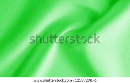 Picture. Texture, background. green emerald silk fabric. This medium / silky silk fabric has a wonderful shine with slight color variations to give the look a strip in the fabric.