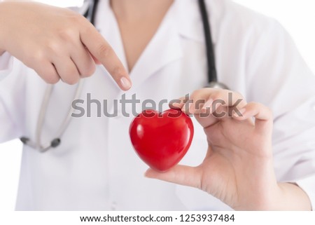 Medicine doctor holding red heart shape in hands on hospital background, medical concept